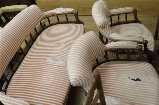 An upholstered settee on mahogany frame and two tub chairs W.140cm